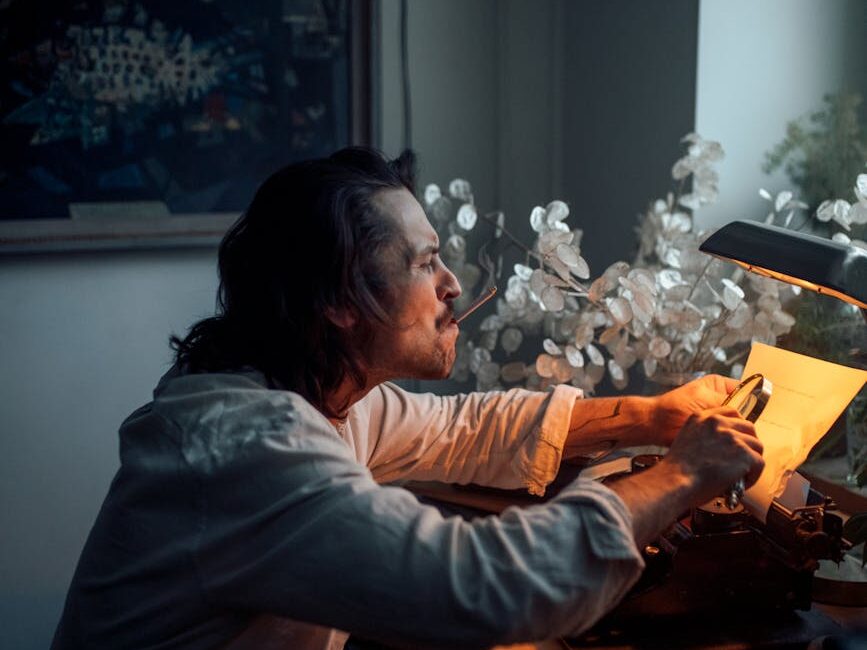 a man with cigarette in mouth holding a magnifying glass on a paper